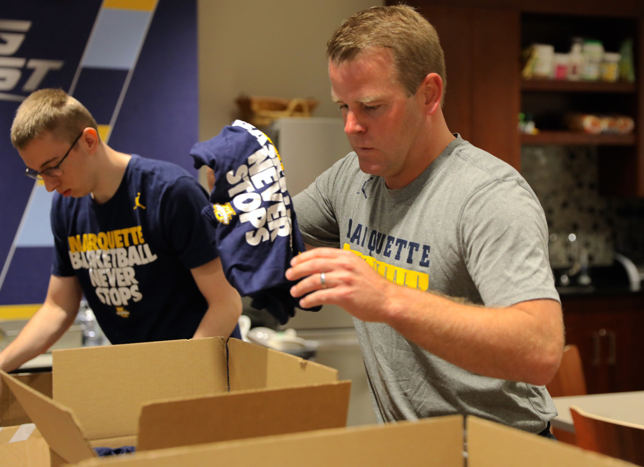 Cole Bovard a sophomore in the College of Arts & Sciences and coach Steve Wojciechowski send supplies to victims in Houston. 

Photo courtesy of Marquette Athletics 