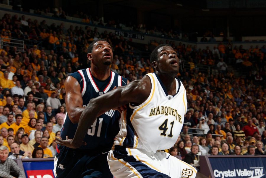 Marquette's Ousmane Barro guards a University of Connecticut player during a men's basketball game January 3, 2006 at the BMO Harris Bradley Center. (Photo courtesy of Marquette Athletics.)