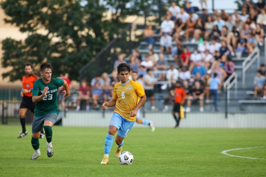 Edrey Caceres (6) dribbles the ball in Marquette's 2-0 win over University of Wisconsin-Green Bay Aug. 26. (Photo courtesy of Marquette Athletics.)
