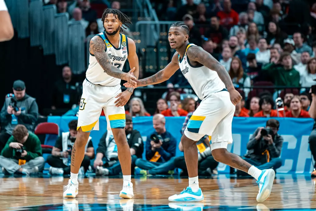 Kam Jones (right) finishes his Marquette career as the program's second all-time leading scorer, amassing 2044 points across 137 games.